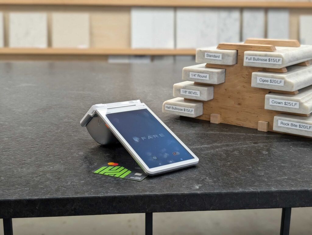 The Fare terminal and a credit card sit on a payment counter