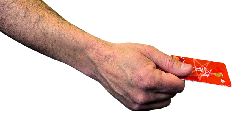 A hand holds a credit card